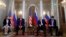 FILE - US President Donald Trump (2nd-L), accompanied by a translator (L), listens to a statement of Russian President Vladimir Putin (2nd-R) at the beginning of a meeting at the Presidential Palace in Helsinki, Finland, July 16, 2018. Putin's Russian translator is on the right. 