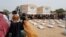 FILE - Sudanese refugees who have fled the violence in their country queue to receive food supplements from World Food Programme (WFP) near the border between Sudan and Chad in Adre, Chad April 26, 2023.