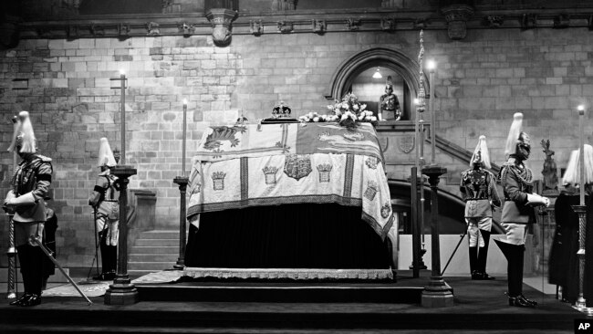 FILE - The remains of King George V lie in state until the royal funeral, with the Household troops standing guard at Westminster Hall in London on Jan. 23, 1936. (AP Photo, File)