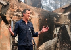 FILE - California Gov. Gavin Newsom speaks at a press conference while touring areas damaged by the Glass Fire at Foothills Elementary School near St. Helena, Calif., Oct. 1, 2020.