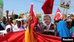 FILE - Somali people carry Turkish and Somali flags as they gather in support of Turkish President Recep Tayyip Erdogan and his government in Somalia's capital Mogadishu, July 16, 2016. 