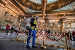 A worker sprays disinfectant at Ramses railway station in Cairo, Egypt, March 20, 2020, as part of a efforts to fight the spread of the coronavirus.