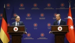 FILE - Turkey's Foreign Minister Mevlut Cavusoglu, right, and German counterpart Heiko Maas speak to reporters after their talks, in Ankara, Turkey, Aug. 25, 2020.