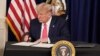 U.S. President Donald Trump signs executive measures for economic relief during a news conference amid the spread of the coronavirus disease, at his golf resort in Bedminster, N.J., Aug. 8, 2020. 