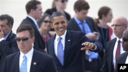 President Barak Obama greets supporters on the tarmac of the Grand Rapids, Mich. airport, Thursday, Aug. 11, 2011, on his way to Holland, Mich. (AP Photo/Adam Bird)