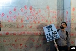 FILE —Hand prints are seen on the wall of Union Station building at a pro-Palestinian rally asking for a cease fire in Gaza, in Washington, November 17, 2023.