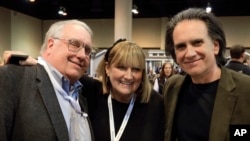 FILE - The children of Berkshire Hathaway Chairman and CEO Warren Buffett, from left, Howard Buffett, Susie Buffett, and Peter Buffett, pose for a photo at the CenturyLink Center exhibit hall in Omaha, Neb., May 1, 2015.