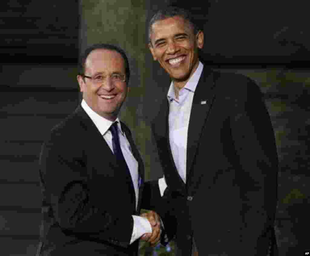 President Barack Obama, right, greets French President Francois Hollande on arrival for the G8 Summit Friday, May 18, 2012 at Camp David, Md. (AP Photo/Charles Dharapak)