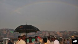A rainbow forms in the horizon, as Rohingya refugees gather at Thangkhali refugee camp in Cox's Bazar, Bangladesh, Oct. 5, 2017. 