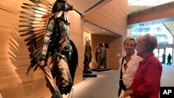 Visitors take in an installation inside the James Museum of Western & Wildlife Art in St. Petersburg, Fla., April 11, 2018. When you think of Florida, the icons of the American West don't usually come to mind.