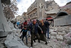 Syrians gather at the site of a regime airstrike in Ariha town in Syria's last major opposition bastion of Idlib, Jan. 15, 2020.