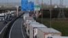 FILE - Trucks queue on the motorway as French Customs Officers increase controls on transported goods to protest the lack of resources as the Brexit date approaches, in Calais, France, March 13, 2019.