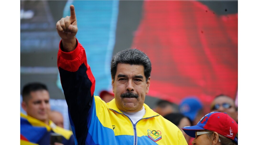 FILE - Venezuela's President Nicolas Maduro leads a rally condemning U.S. economic sanctions imposed on Venezuela, in Caracas, Aug. 10, 2019.