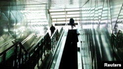 Park Gyung-sun gets out of a subway station as he delivers a parcel in Seoul, South Korea, Feb. 8, 2023.