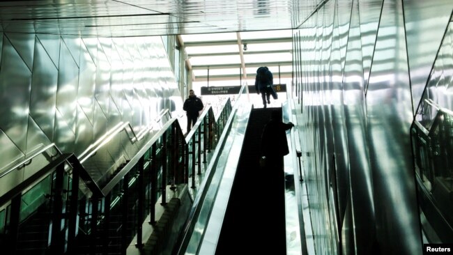 Park Gyung-sun gets out of a subway station as he delivers a parcel in Seoul, South Korea, Feb. 8, 2023.