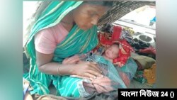 নৌকাতেই ছেলে সন্তান জন্ম দেন ইয়াকুব আলীর স্ত্রী মিনারা খাতুন। (ছবি- বাংলা নিউজ 24) 