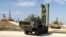 FILE - This photo made from the footage taken from the Russian Defense Ministry official web site on Nov. 27, 2015, shows Russian S-400 air defense missiles being deployed at the Hemeimeem air base in Syria.