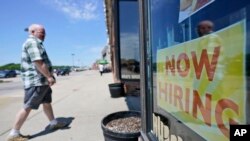 FILE: A man walks into 5th Avenue Deli and Grill, June 4, 2021, in Mayfield Heights, Ohio. 