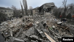Rescuers work at the site of a maternity ward of a hospital destroyed by a Russian missile attack, as their attack on Ukraine continues, in Vilniansk, Zaporizhzhia region, Ukraine, Nov. 23, 2022. 