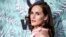 FILE - In this Feb. 24, 2017, file photo, Michelle Dockery arrives at the 10th Annual Women in Film Pre-Oscar Cocktail Party at Nightingale Plaza in Los Angeles. Filming has begun for the “Downtown Abbey” movie. Dockery, who plays Lady Mary in the global hit, posted a photo on Instagram with the caption, “And...we’re off.” 