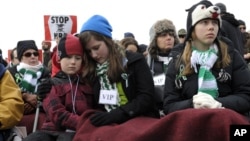 A crowd listens to speaker during a rally against gun violence near the Washington Monument in Washington, January 26, 2012. 