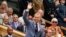 FILE - Former Olympian Chris Hoy waves as he is introduced on Centre Court ahead of the third round match between Cameron Norrie of Britain and Alexander Zverev of Germany at the Wimbledon tennis championships in London, July 6, 2024.