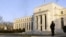 A guard stands outside the Federal Reserve Building in Washington, January 14, 2010 (file photo)
