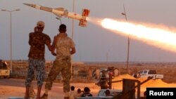 Fighters of Libyan forces allied with the U.N.-backed government fire a rocket at Islamic State fighters in Sirte, Libya, Aug. 4, 2016. 