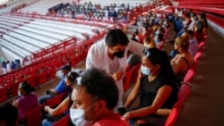 A woman receives the Pfizer-BioNTech COVID-19 vaccine, during a mass vaccination program for people over 50 years of age at a baseball stadium in Ciudad Juarez, Mexico, June 22, 2021. (Jose Luis Gonzalez/Reuters)