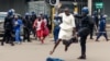 An anti-riot police man in Zimbabwe tackles a woman with his boot as they dispersed a crowd gathered to hear an address by leader of the MDC (Movement for Democratic Change) Alliance, Nelson Chamisa at Morgan Tsvangirai House, the party headquarters, in H