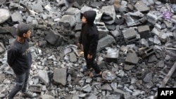 Palestinian children inspect damage at the site of an Israeli strike the previous night in Jabaliya, Gaza Strip, on Jan. 1, 2025.