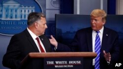 President Donald Trump talks with Bill Bryan, head of science and technology at the Department of Homeland Security, as he speaks about the coronavirus April 23, 2020, in Washington, D.C. 