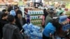 People line up to buy cartons of bottled water at a supermarket after reports on heavy levels of benzene in local tap water, in Lanzhou, Gansu province, April 11, 2014. 