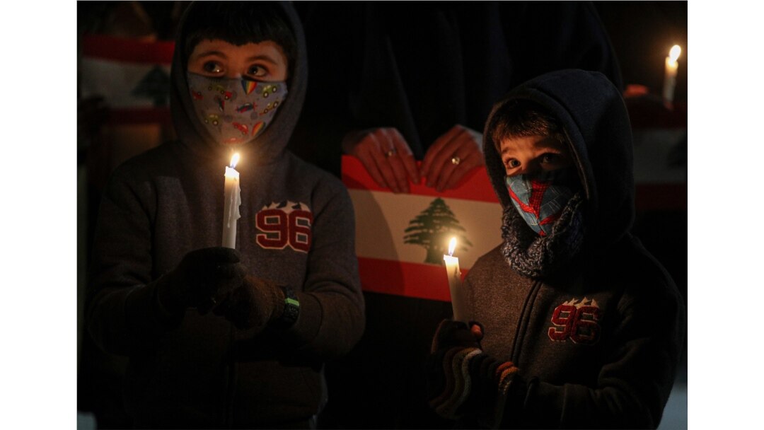 Children take part in a vigil for the victims of the deadly explosion which devastated the port and large parts of the city of Beirut, in front of the Lebanon Embassy in Santiago, Chile, Aug. 10, 2020.