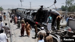 Railway staff work at the site, after a blast near a railway track in Quetta