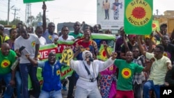 Demonstrators hold banners reading in Swahili "Sitaki nuclear" (I don't want nuclear), during an anti-nuclear protest in Kilifi, Kenya, Oct. 11, 2024.