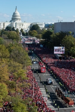 With the Capitol in the background, the Washington Nationals celebrate the team's World Series baseball championship over the Houston Astros, with their fans in Washington, Nov. 2, 2019.