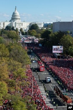 With the Capitol in the background, the Washington Nationals celebrate the team's World Series baseball championship over the Houston Astros, with their fans in Washington, Nov. 2, 2019.