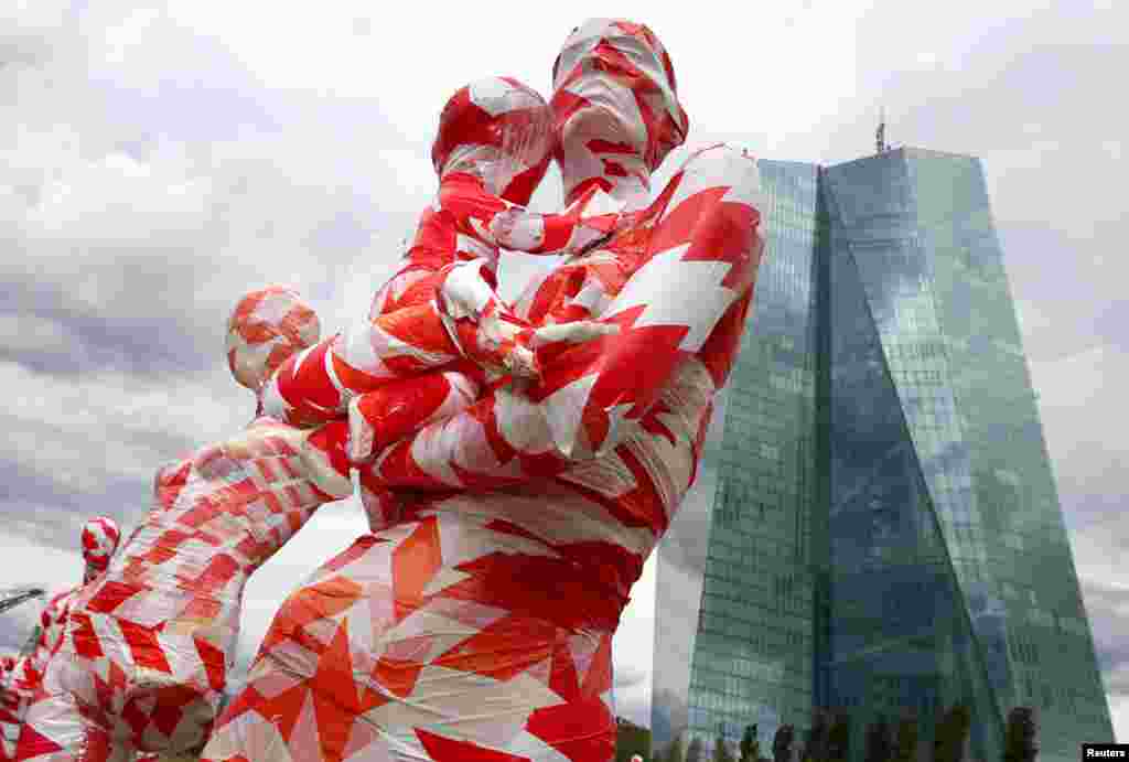 A partially incomplete display of mannequins wrapped in a barrier tape to symbolize the coronavirus disease (COVID-19) crisis, as part of the art installation &quot;It is like it is&quot; by German art student Dennis Josef Meseg, is seen in front of the European Central Bank headquarters in Frankfurt, Germany.