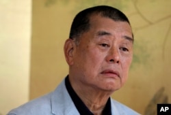 FILE - Hong Kong media tycoon Jimmy Lai pauses during an interview in Hong Kong on July 1, 2020.