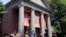 FILE - A tour group walks through the campus of Harvard University in Cambridge, Massachusetts.