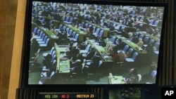 The U.N. General Assembly vote approving the first U.N. treaty regulating the international arms trade, April 2, 2013.