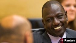FILE - Kenyan Deputy President William Ruto speaks to his attorney at the International Criminal Court in The Hague, Sept. 10, 2013.