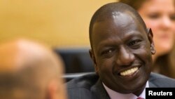 FILE - Kenyan Deputy President William Ruto speaks to his attorney at the International Criminal Court in The Hague, Sept. 10, 2013.