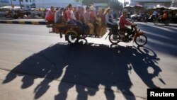 Garment workers leave a factory for home after work, in Phnom Penh, file photo. 