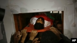 Palestinian mourners carry the body of 29-year-old activist Ibrahim Abu Thuraya who was shot and killed by Israeli troops Friday, in clashes on the Israeli border with Gaza, during his funeral in Gaza City, Saturday, Dec. 16, 2017. Abu Thuraya lost legs and an eye in Israeli bombing during the 2008 Israel and Gaza war. 