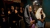 Women pray for Alexander Mora, one of 43 students missing since September, whose bone fragment has now been positively identified among charred remains found near a garbage dump, at the Mora family home in the town of El Pericon, Mexico, Dec. 7, 2014.