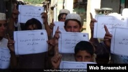 FILE - IS social media distributed photos of children holding placards in Islamic State territories offering "congratulations" on American deaths, apparently in reference to a Florida shooting, on June 12, 2016. In May 2019, IS is increasing attacks and social media posts.