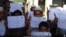FILE - IS social media distributed photos of children holding placards in Islamic State territories offering "congratulations" on American deaths, apparently in reference to a Florida shooting, on June 12, 2016. In May 2019, IS is increasing attacks and social media posts.