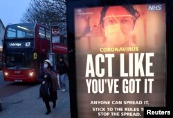 A public health information message is seen at a bus stop in West Ealing as the South African variant of the novel coronavirus is reported in parts of the United Kingdom amid the spread of the coronavirus, London, Britain, Feb. 1, 2021.